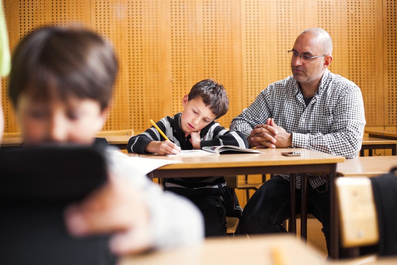 Teacher helping child