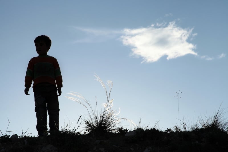 boy playing alone in nature