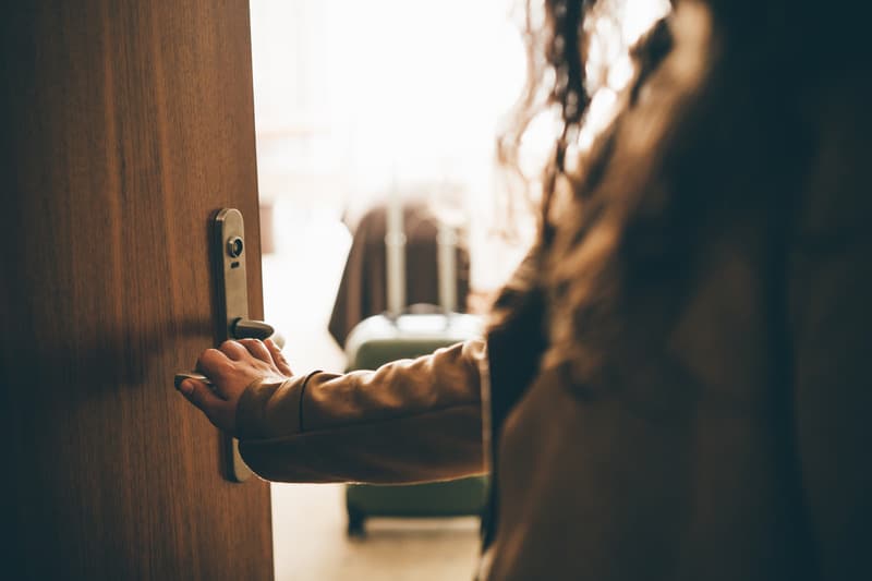 Woman opening motel door
