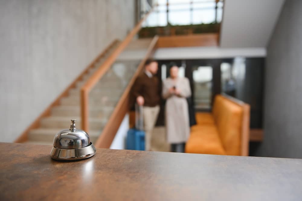 Couple on a business trip doing check-in at the hotel