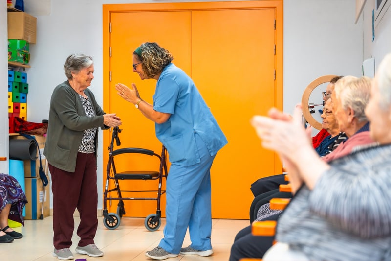 Nurse clapping for elder lady