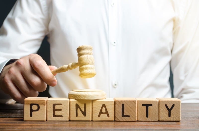 Judge with a gavel above the word penalty