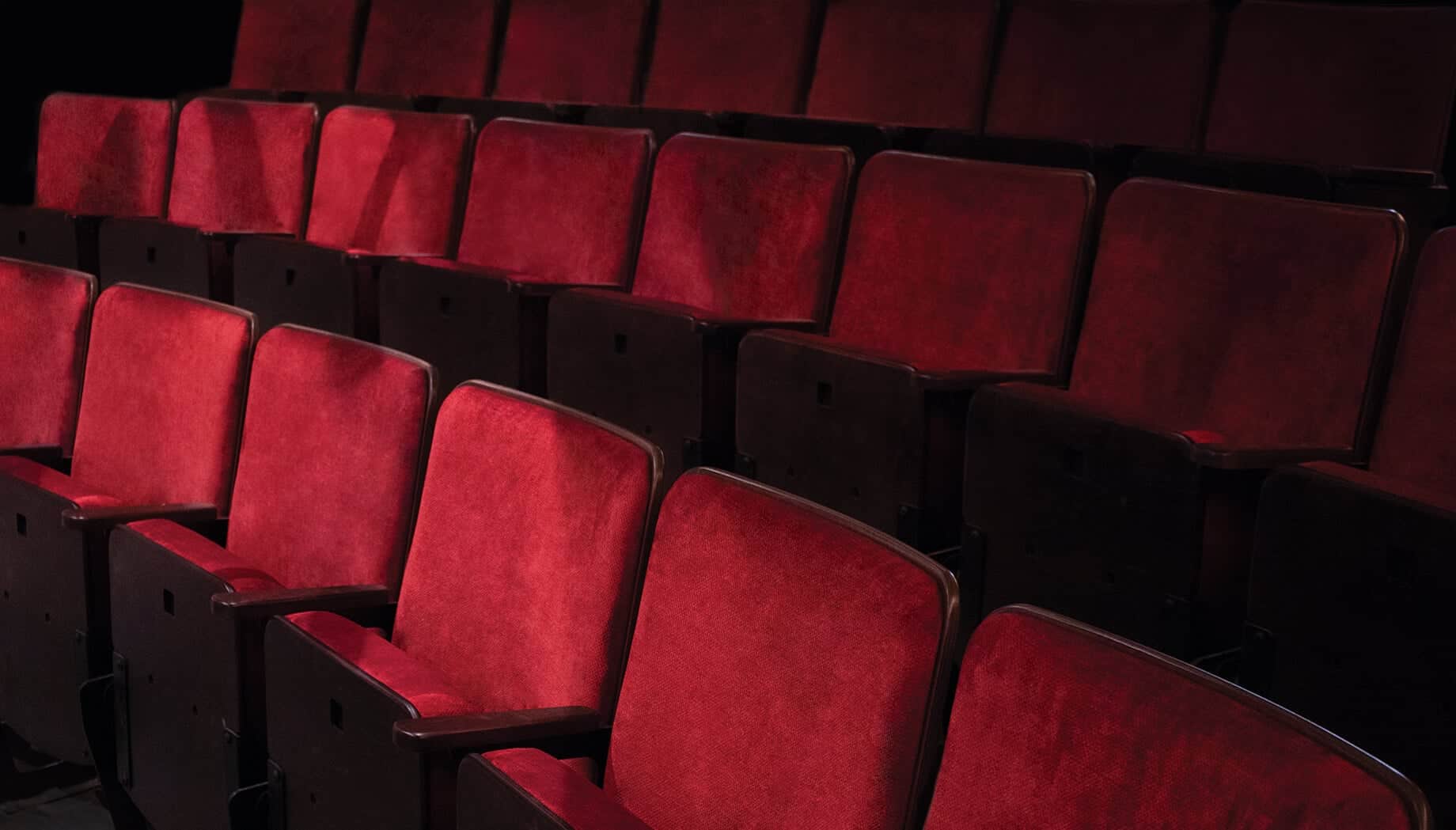 Empty red velvet seats at the Round House Theatre, the venue at the center of a sexual abuse lawsuit.