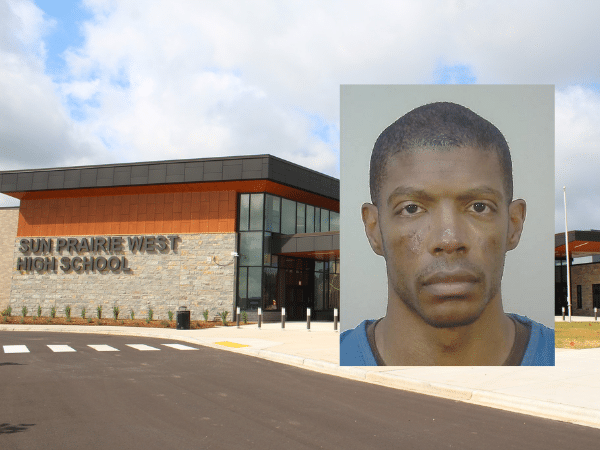 Booking photo of Robert Gilkey-Meisegeier, former dean of students at Sun Prairie West High School, shown in front of a background image of the school building. He is facing 15 felony charges, including child sexual exploitation and possession of child pornography.