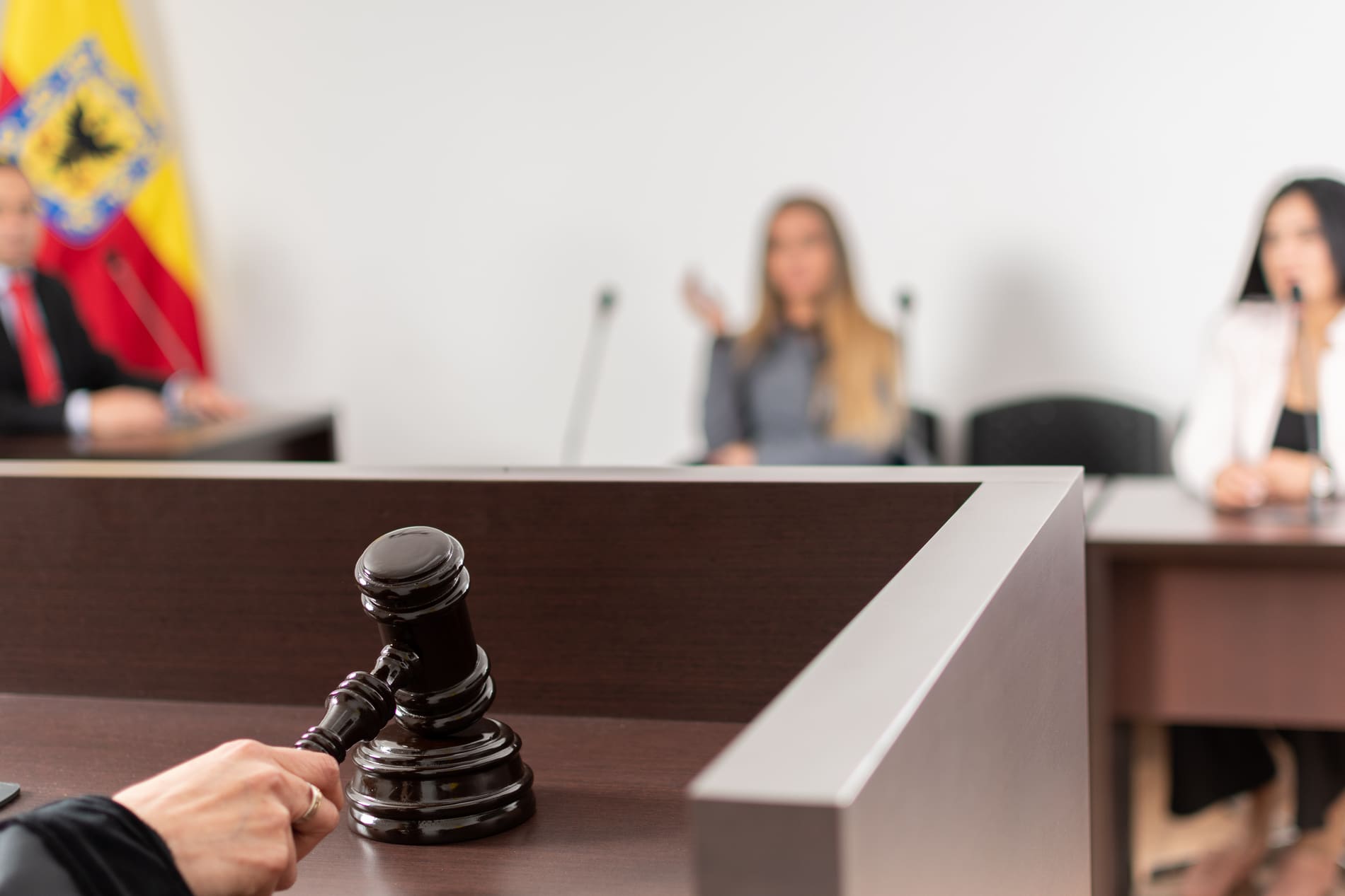 Closeup blurred view of woman in court room talking to judge